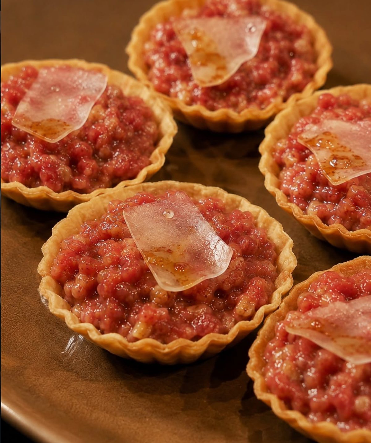 Small tartlets topped with finely chopped meat